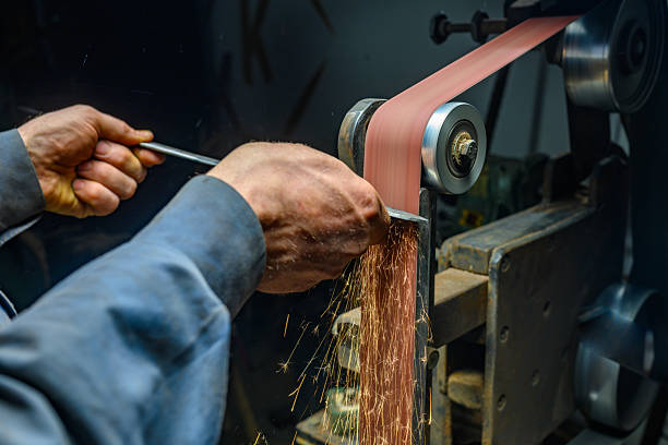 Grinding workmanship sparks in saw manufacturing workshop
