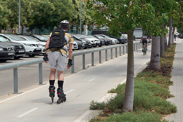 Viladecans, Barcelona - September 17, 2025: A man inline skating on an urban bike lane. The image captures active mobility and alternative transport in a city environment.