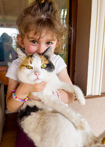 istock Happy girl hugging white cat 2236245210