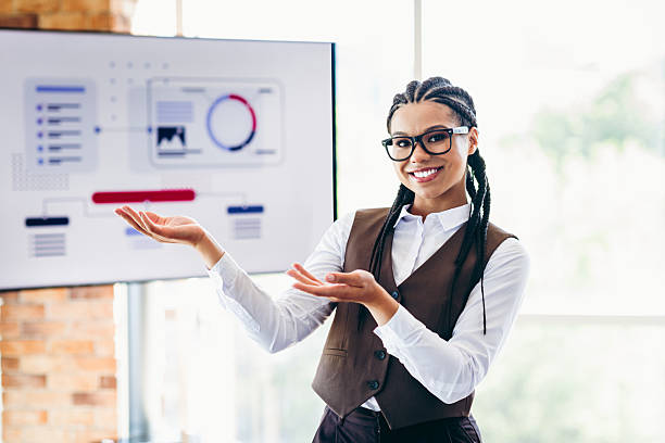 istock Confident businesswoman presenting data visuals during a professional office meeting, showcasing analytics and strategic concepts 2236246017