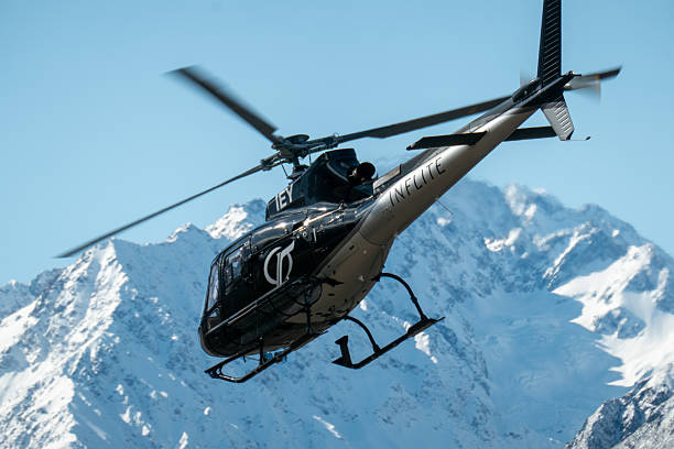 An Inflite Airbus Helicopters H125, registration ZK-IEY, taking off from Mount Cook Airport and taking tourists on a flight around the southern alps of the South Island. In the background is the peak of Aoraki Mount Cook. This image was taken on a cold, windy and sunny afternoon on 11 September 2025.