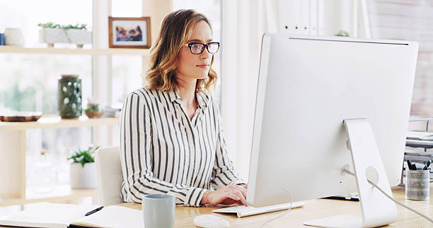 istock Business woman, workplace and computer for typing email with policy development, research or feedback. Desktop, reading or consultant in office to review project, compliance and information online 2236247321
