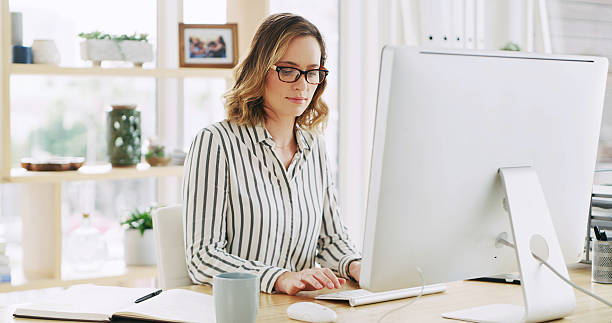 istock Business woman, company and computer for typing email with policy development, research or feedback. Desktop, reading and consultant in office to review project, compliance and check schedule online 2236247370