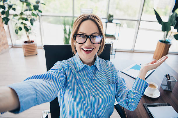 istock Confident businesswoman taking a selfie in a modern office setting, showcasing her professionalism and workplace charisma 2236251663