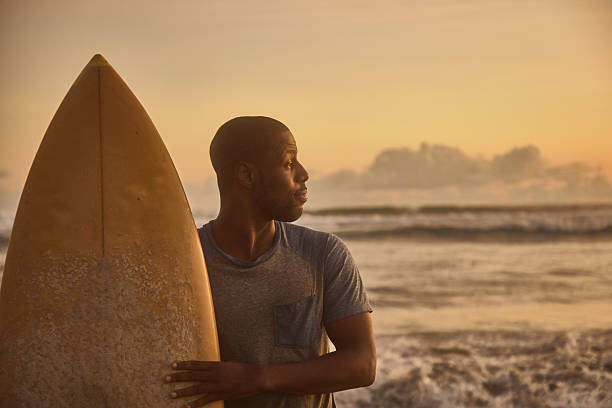 portrait of latin surfer man rides the tropical waves in Mexico Latin America, hispanic people surfing in summer sport activity
