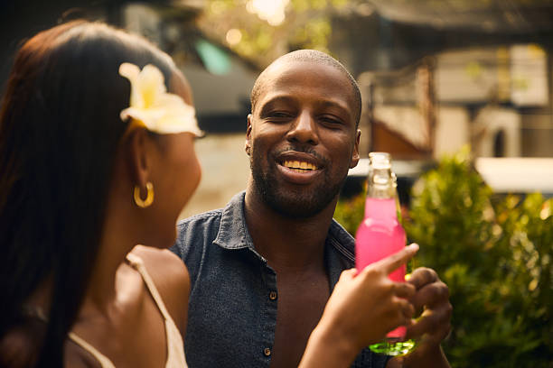 istock Couple enjoying a refreshing pink drink outdoors during a sunny day 2236253010