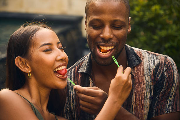 istock Couple enjoying fresh fruit outdoors emphasizing joy and shared moments 2236254121