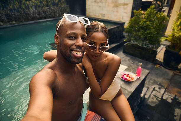 istock Couple enjoying a tropical poolside setting with stylish summer vibes 2236254422