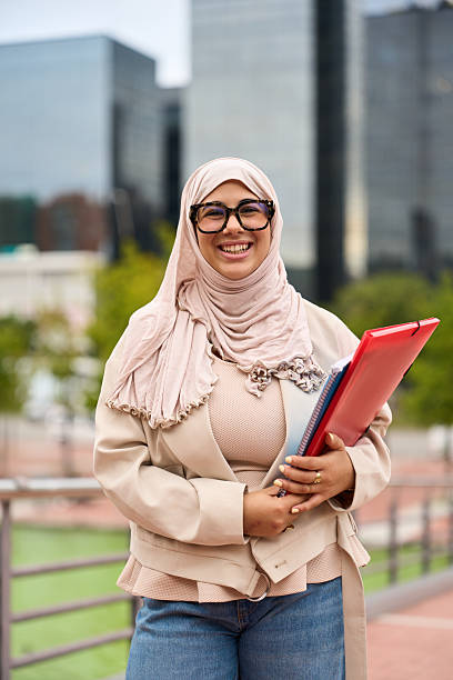 istock Happy muslim student holding books in urban setting 2236256042