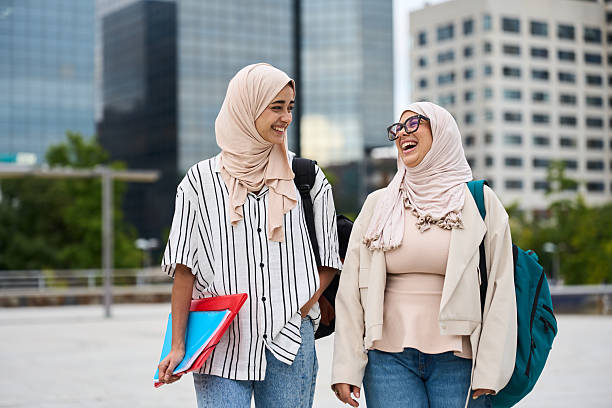 istock Muslim female students laughing walking in city 2236256087