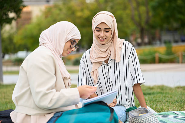 istock Muslim women students studying outdoors in a park 2236256239