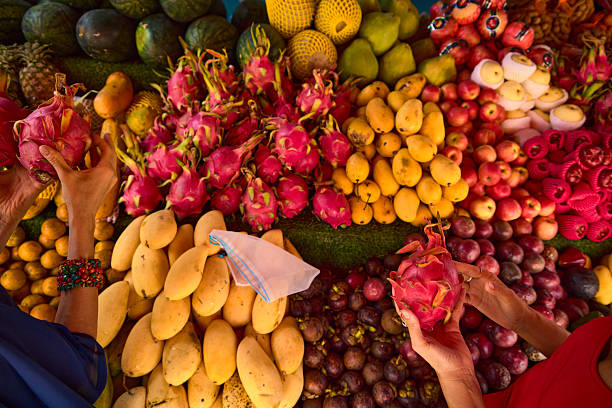 Colorful fruit market display with dragon fruits and assorted tropical produce