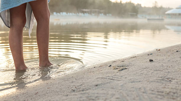 istock Feet in the water at the beach 2236256630