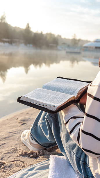 istock Reading the Bible by the Lake 2236256641