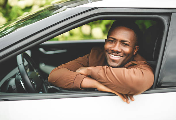 istock young black man with his new car 2236257555
