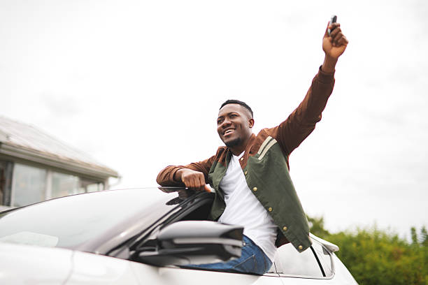 istock young black man with his new car 2236257583