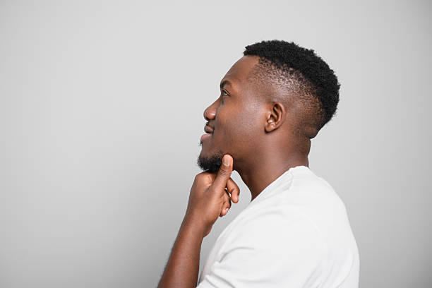 istock Black men wearing white shirt in studio shot on white background 2236258060