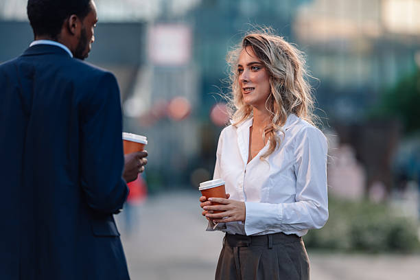 istock Business colleagues having coffee break conversation outside office 2236259713