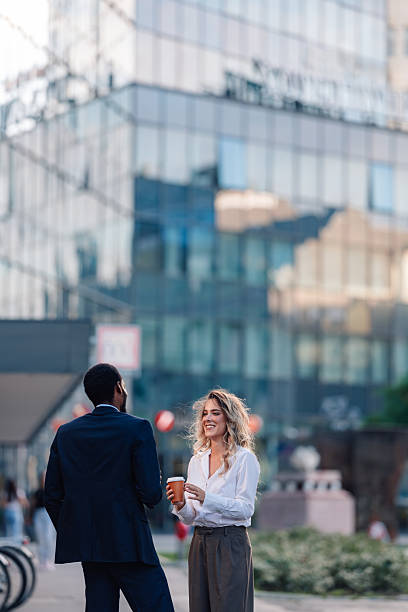istock Diverse business professionals having coffee break outdoors 2236260240