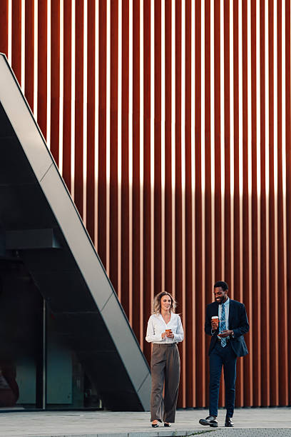 istock Diverse business colleagues walking and talking during coffee break 2236260309