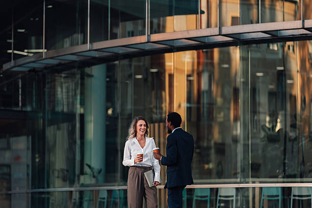 istock Business colleagues having coffee break outdoors at office building 2236260441