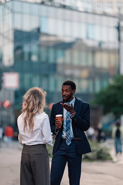 istock Business colleagues having coffee break conversation outdoors 2236260757
