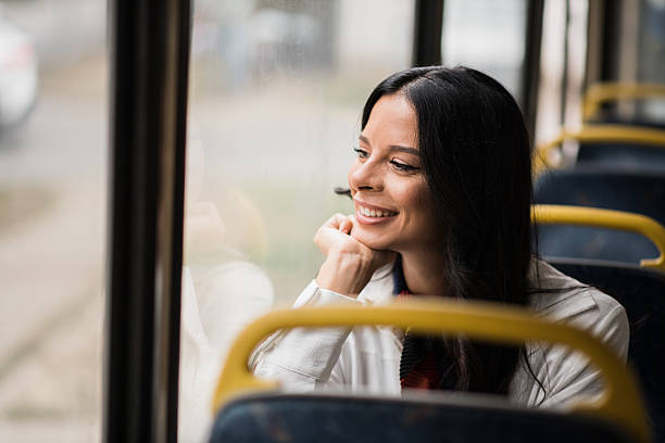 istock Smiling commuter woman on empty bus 2236261031
