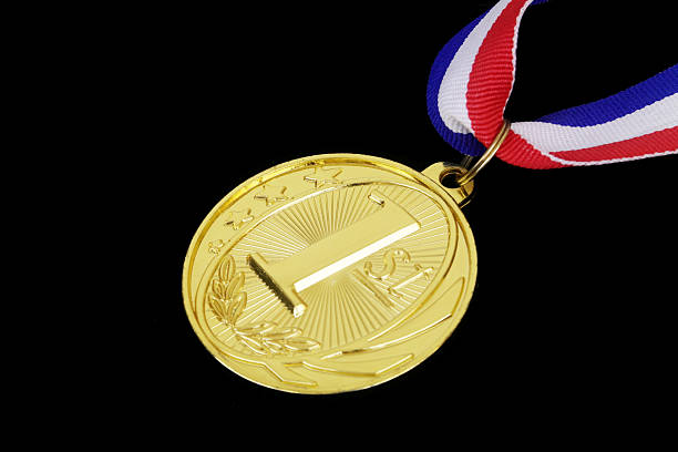 istock Gold medal with ribbon isolated on black 2236261167