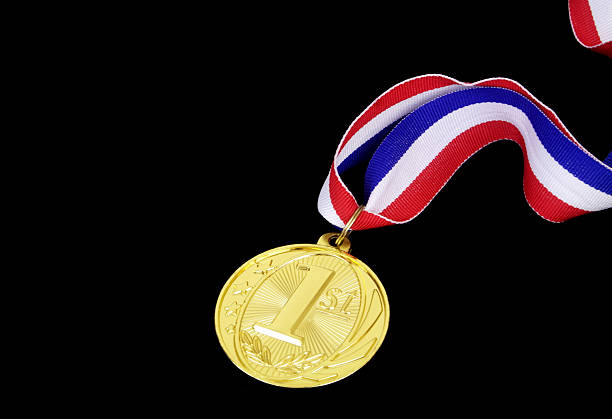 istock Gold medal with ribbon isolated on black 2236261231