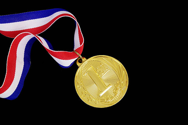 istock Gold medal with ribbon isolated on black 2236261278