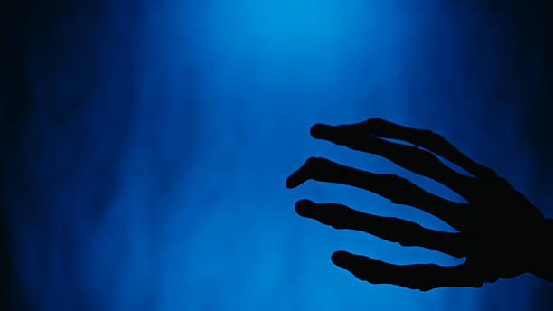 Shaking Hand Silhouette Halloween Skeleton Blue Background.