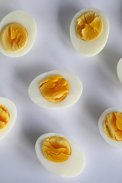 istock Full frame image of group of hard-boiled chicken egg halves isolated on white background, studio shot, healthy eating poster wallpaper background design, elevated view 2236262346