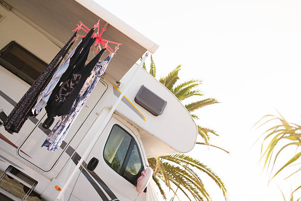 Mature couple discussing besides their motorhome during summer day