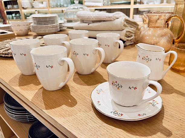 istock Elegant white ceramic tea cups with floral designs arranged on wooden table, showcasing delicate craftsmanship and inviting atmosphere for dining or tea parties 2236264127