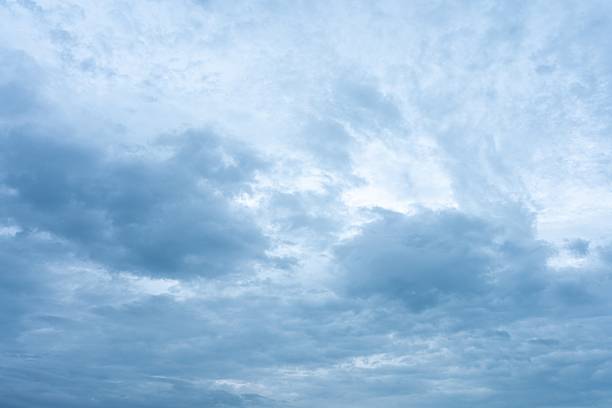 High resolution photograph of a sky filled with a mix of blue and gray cumulus clouds Perfect for backgrounds