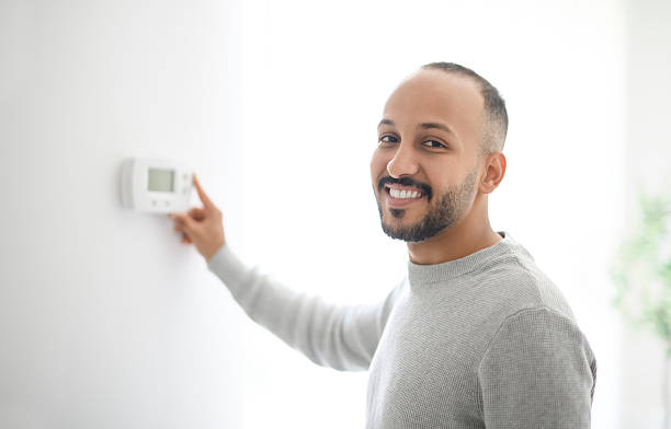 istock young islamic arab using thermostat at home 2236267103