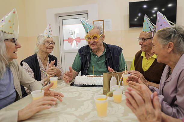 istock Senior Friends Enjoy Birthday Celebration With Cake 2236270917