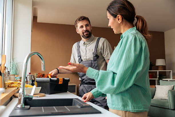istock Woman Showing Faucet Problem to Handyman 2236271078