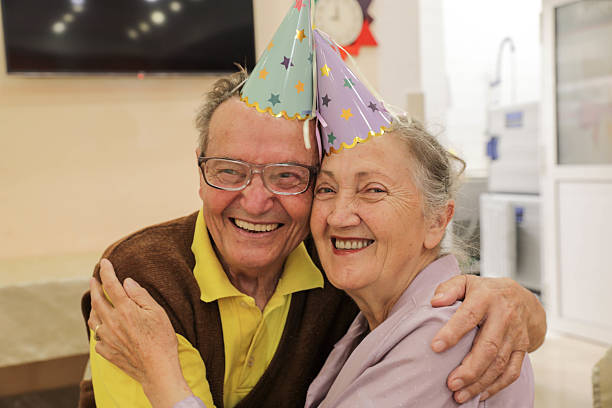 istock Senior Friends Enjoy Birthday Celebration With Cake 2236271338