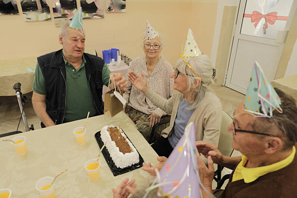 istock Senior Friends Enjoy Birthday Celebration With Cake 2236271422