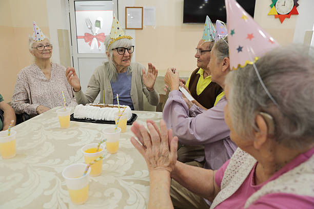 istock Senior Friends Enjoy Birthday Celebration With Cake 2236271482