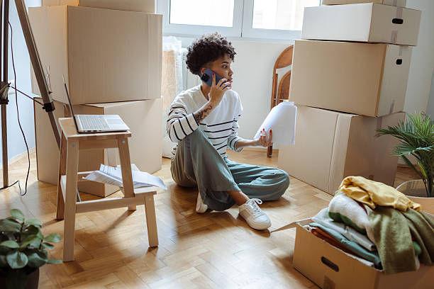 istock Young woman preparing for a move while multitasking on the phone 2236271500