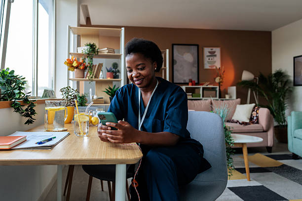 istock Black Female Healthcare Worker Using Mobile at Home 2236272276