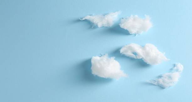 istock Clouds made of tasty white cotton candy on light blue background, flat lay. Space for text 2236276360