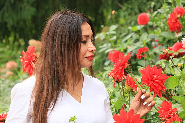 A person holding two red and two white roses (Rosa × centifolia Muscosa') in their left hand seen from above. Concept: romance, valentine's day, gift, anniversary, celebration, congratulation,
