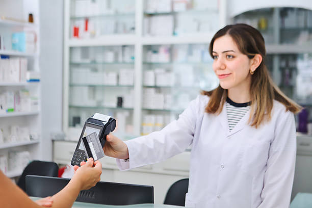Customer making a payment with a credit card at the pharmacy.