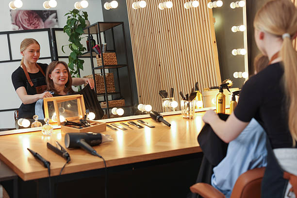 istock Hairstylist working with client near mirror in salon 2236277425