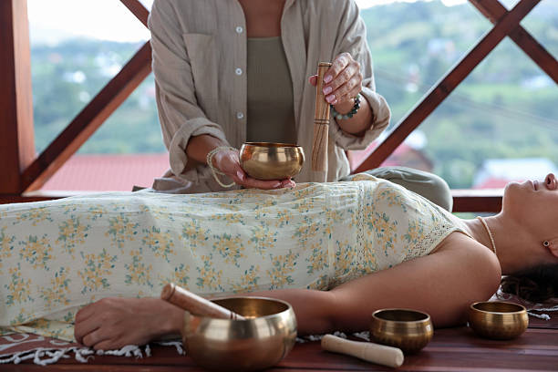 istock Woman undergoing singing bowl therapy lying on floor indoors, closeup 2236278551