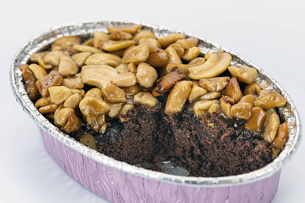 Caramel toffee cake nut chocolate dessert sweet baked snack delicious are combined in this rich chocolate cake topped with caramelized nuts creating decadent and inviting treat