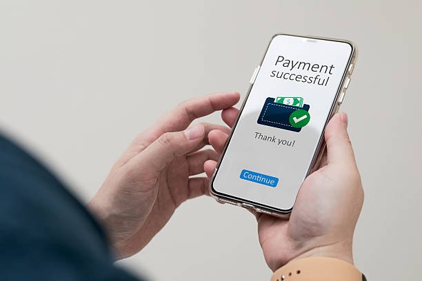 istock Payment successful notification system. Close-up view of customer smartphone using online banking application to pay for online purchases. 2236278824
